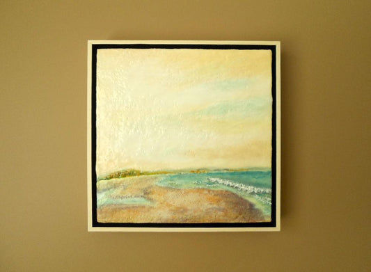 Encaustic painting of beach with yellow skies.