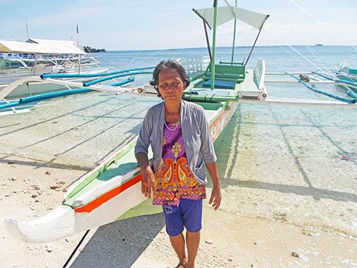 Hog farmer wearing a white and red shirt at his farm in Bolivia.