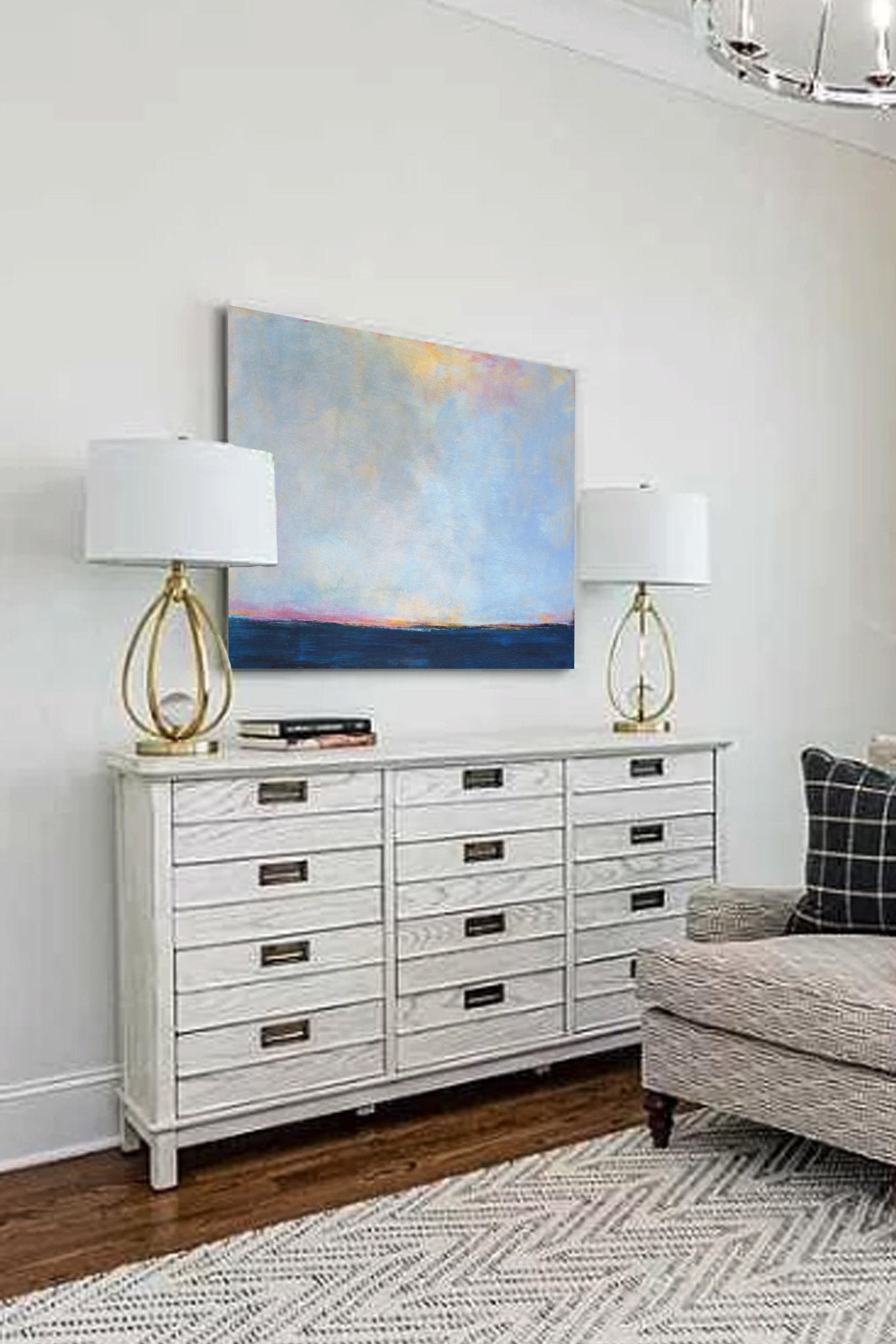 Abstract coastal artwork "Local Celebrity" 24x36 in. above a console table in the living room.