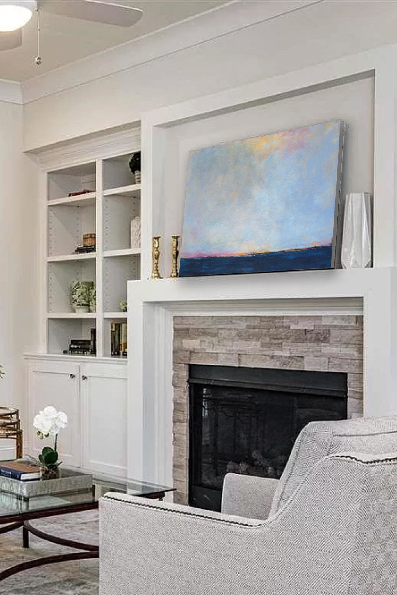 Blue horizon abstract landscape "Local Celebrity" 24x36 in. sits on a fireplace mantel.