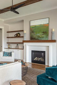 Green abstract landscape painting "Spring Envy," fine art print by Victoria Primicias, decorates the fireplace.