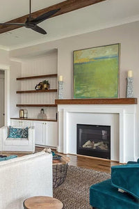Yellow-green abstract coastal wall art "Above Anything," fine art print by Victoria Primicias, decorates the fireplace.