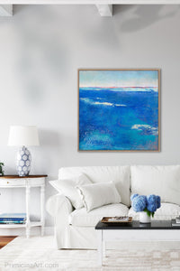 Coastal blue abstract beach art "Aegean Crossing," digital print by Victoria Primicias, decorates the living room.