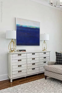 Navy blue abstract beach wall decor "After Hours," downloadable art by Victoria Primicias, decorates the living room.