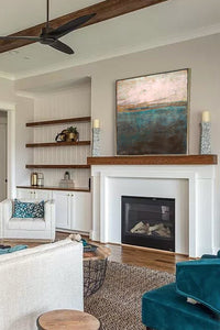 Impressionist abstract seascape painting "Almost Forgotten," digital art by Victoria Primicias, decorates the fireplace.