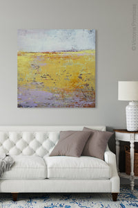 Yellow abstract landscape painting "Amalfi Sound," wall art print by Victoria Primicias, decorates the living room.