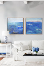 Load image into Gallery viewer, Blue abstract coastal wall art &quot;Arctic Tidings,&quot; wall art print by Victoria Primicias, decorates the living room.
