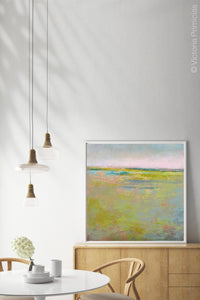Yellow green landscape painting "Bellini Fields," digital art by Victoria Primicias, decorates the dining room.