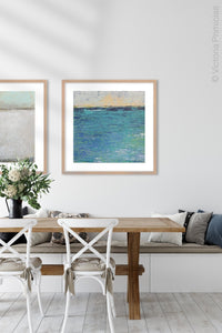 Blue abstract beach wall art "Beryl Basin," printable wall art by Victoria Primicias, decorates the dining room.