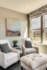 Unique abstract landscape painting "Blue Promise," giclee print by Victoria Primicias, decorates the living room.