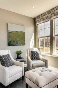 Modern abstract landscape art "Brassy Pastures," downloadable art by Victoria Primicias, decorates the living room.