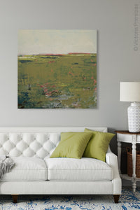 Modern abstract landscape art "Brassy Pastures," digital print by Victoria Primicias, decorates the living room.