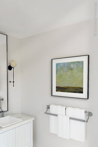 Square abstract landscape art "Canary Winds," digital print by Victoria Primicias, decorates the bathroom.