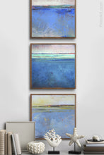 Load image into Gallery viewer, Blue abstract beach art &quot;Carolina Shores,&quot; metal print by Victoria Primicias, decorates the hallway.
