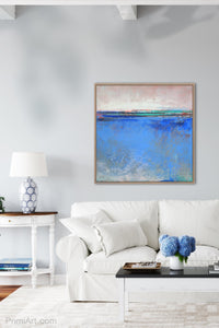 Blue abstract beach art "Carolina Shores," metal print by Victoria Primicias, decorates the living room.