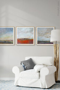 Gray landscape painting "Casual Vacancy," digital print by Victoria Primicias, decorates the living room.