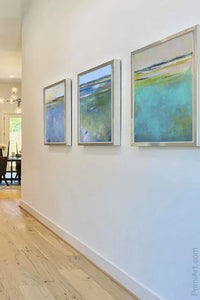 Blue abstract seascape painting"Color Dance," downloadable art by Victoria Primicias, decorates the entryway.