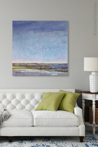 Blue abstract seascape painting "Confetti Chorus," wall art print by Victoria Primicias, decorates the living room.