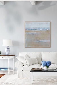 Beige muted abstract seascape painting "Crib Sheets," digital artwork by Victoria Primicias, decorates the living room.