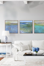Load image into Gallery viewer, Blue abstract coastal wall art &quot;Daily Caller,&quot; metal print by Victoria Primicias, decorates the living room.
