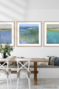 Blue abstract beach wall decor "Daily Caller," metal print by Victoria Primicias, decorates the dining room.