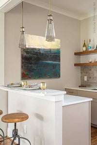 Indigo abstract beach painting "Deep End," metal print by Victoria Primicias, decorates the kitchen.