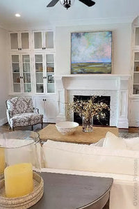 Coastal abstract landscape painting "Delicate Dance," giclee print by Victoria Primicias, decorates the living room.