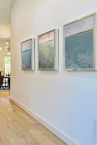 Teal muted landscape art "Delicate Dawn," downloadable art by Victoria Primicias, decorates the entryway.