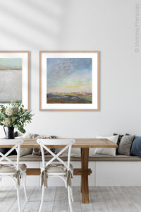 Square landscape painting "Faraway Nearby," downloadable art by Victoria Primicias, decorates the dining room.