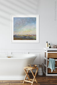 Square abstract landscape painting "Faraway Nearby," digital print by Victoria Primicias, decorates the bathroom.