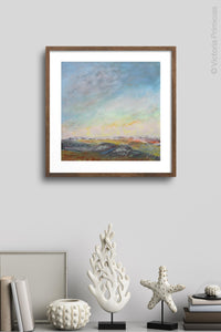 Square abstract landscape painting "Faraway Nearby," wall art print by Victoria Primicias, decorates the wall.