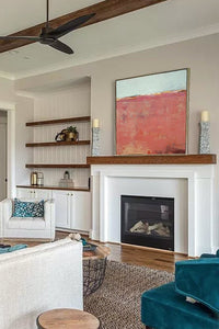 Minimalist abstract beach painting "Feral Tidings," digital print by Victoria Primicias, decorates the fireplace.