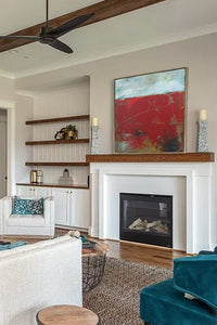 Square red abstract beach wall art "Ferrari Run," digital print by Victoria Primicias, decorates the fireplace.