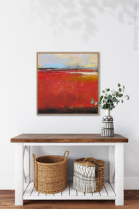 Large red abstract beach wall decor "Fire Sea," wall art print by Victoria Primicias, decorates the entryway.