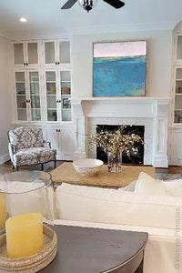 Bluegreen abstract landscape painting "Frisco Bay," canvas wall art by Victoria Primicias, decorates the living room.
