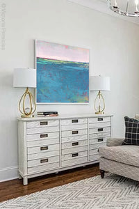 Bluegreen abstract coastal wall decor "Frisco Bay," giclee print by Victoria Primicias, decorates the living room.