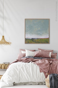 Serene abstract coastal wall decor "Golden Lining," digital print by Victoria Primicias, decorates the bedroom.