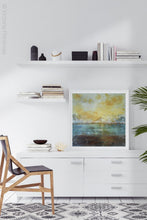 Load image into Gallery viewer, Coastal yellow abstract beach wall decor &quot;Guardian Light,&quot; digital artwork by Victoria Primicias, decorates the office.
