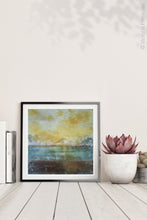 Load image into Gallery viewer, Coastal yellow abstract beach wall decor &quot;Guardian Light,&quot; digital art landscape by Victoria Primicias, decorates the shelf.
