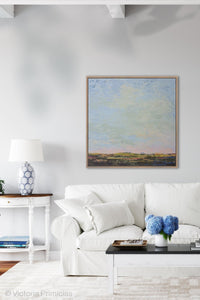 Blue abstract beach artwork "Hello Again," digital print by Victoria Primicias, decorates the living room.