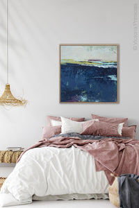 Conteporary indigo abstract beach wall decor "Indigo Blue," digital art by Victoria Primicias, decorates the bedroom.