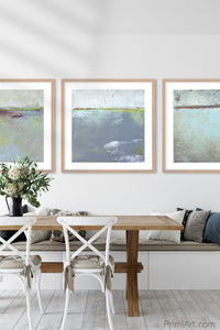 Gray abstract beach art "Marthas Shallows," metal print by Victoria Primicias, decorates the dining room.