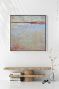 Contemporary beige abstract beach painting "Migrant Shores," digital artwork by Victoria Primicias, decorates the entryway.