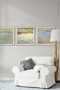 Contemporary beige landscape art "Migrant Shores," printable art by Victoria Primicias, decorates the living room.