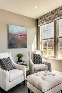 Orange abstract landscape art "Minuet," giclee print by Victoria Primicias, decorates the living room.