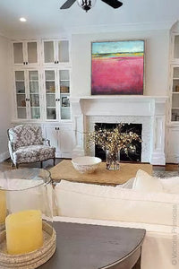 Modern pink abstract ocean wall art "Painted Lady," digital download by Victoria Primicias, decorates the living room.