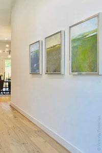 Square contemporary abstract landscape art "Peridot Pastures," printable wall art by Victoria Primicias, decorates the entryway.