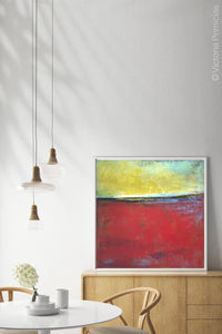 Red and yellow abstract beach wall decor "Poppy Love," giclee print by Victoria Primicias, decorates the dining room.