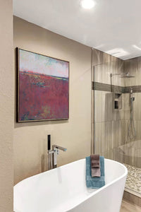 Burgundy abstract seascape painting"Red Tide," digital art landscape by Victoria Primicias, decorates the bathroom.