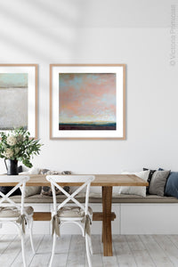 Large abstract coastal wall art "Retiring Sky," digital art landscape by Victoria Primicias, decorates the dining room.